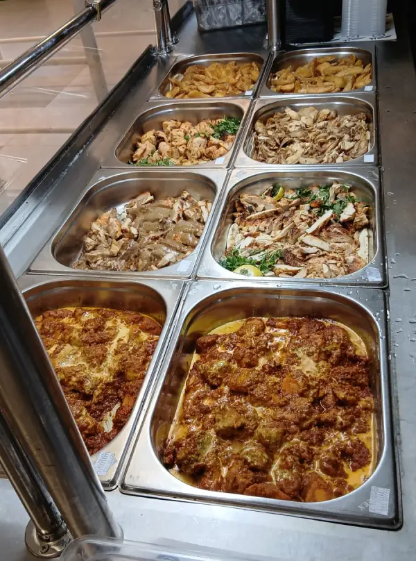 Hot dishes in serving trays on a buffet line
