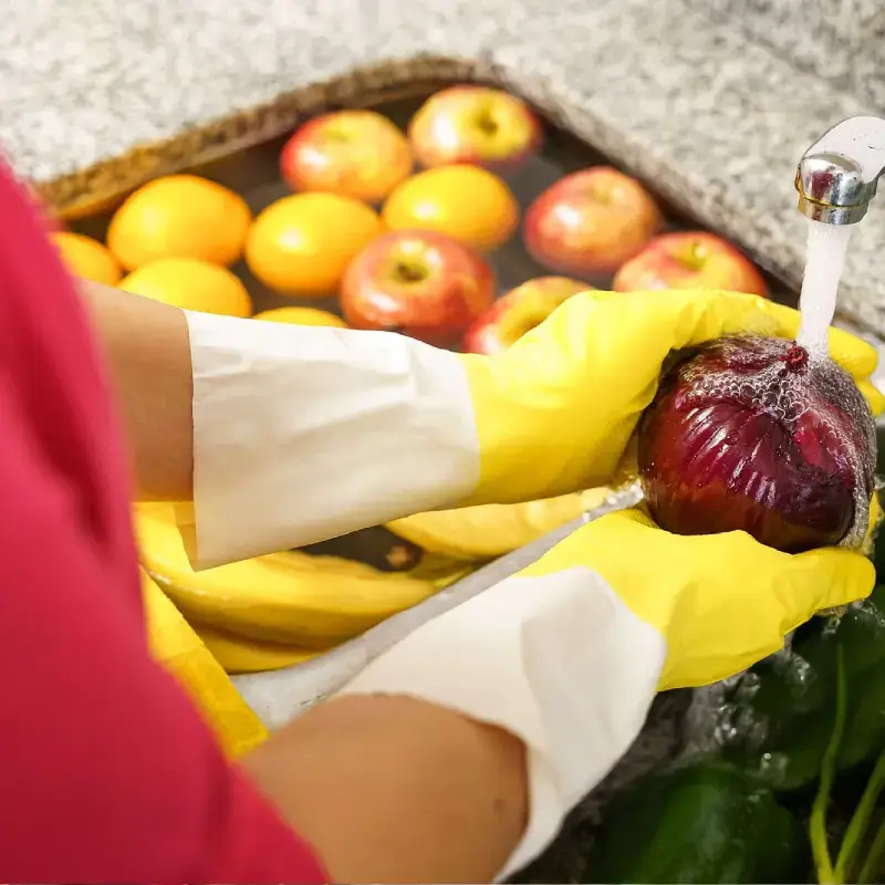 Washing fruit with protective gloves